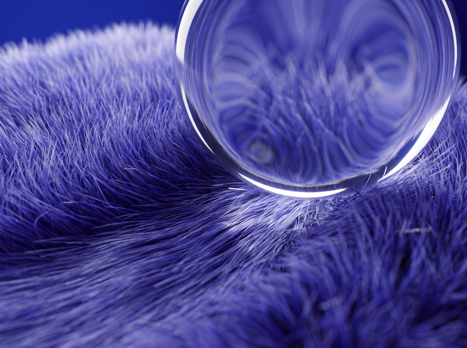 Close-up of a glass sphere resting on fur